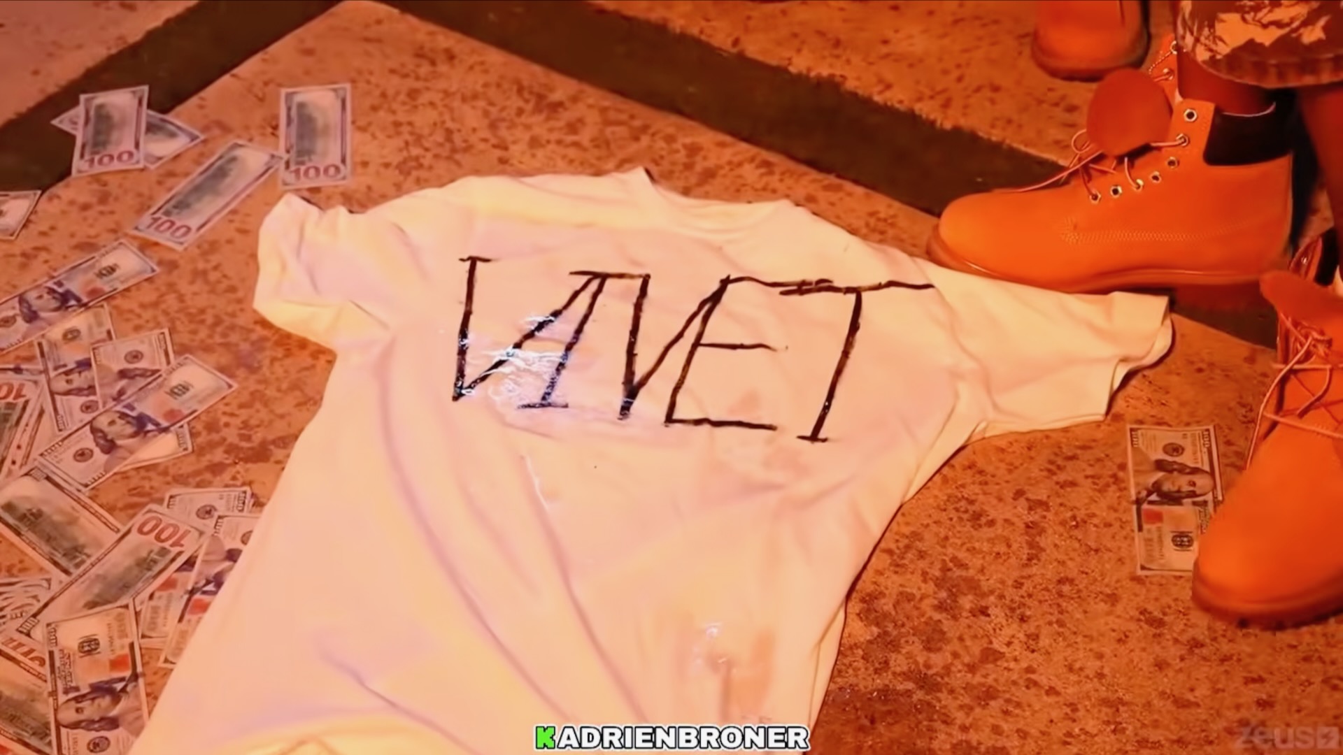 Adrien Broner and DeenTheGreat burning VIVET t shirt (Image via YouTube/@Adrien Broner)